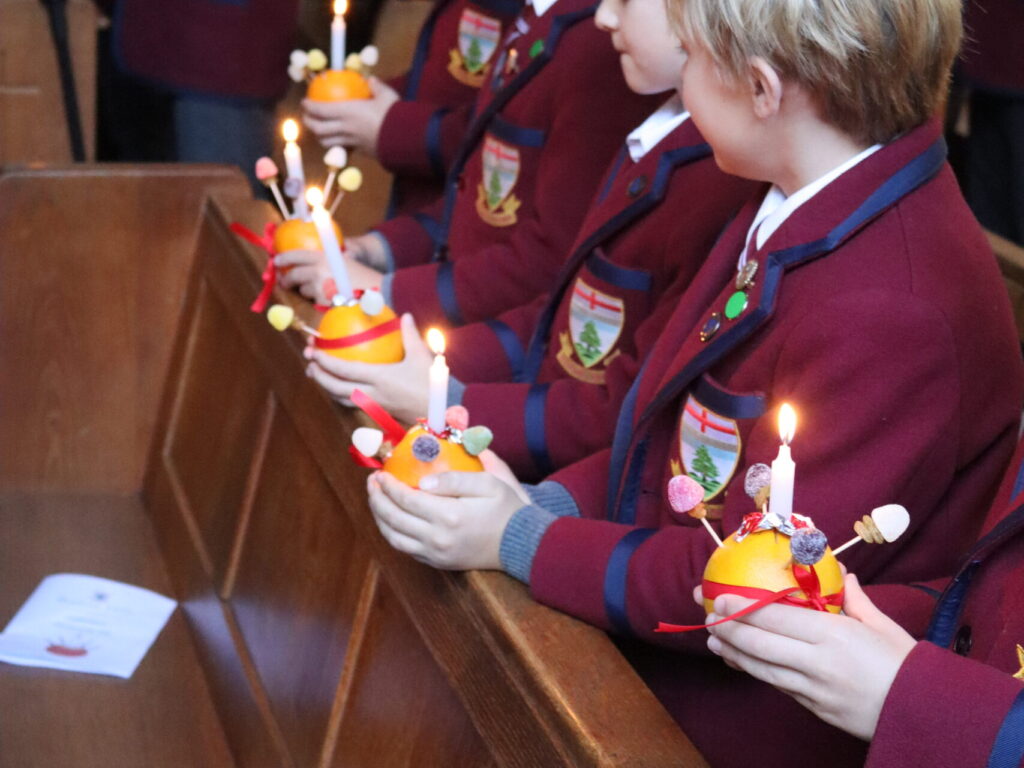 students holding little lights