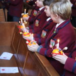 students holding little lights