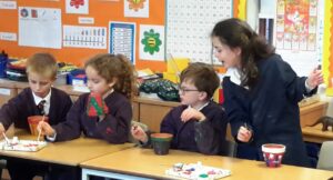 Children hard at work with their plant pots