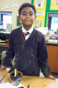 One of the school children with their newest plant creation