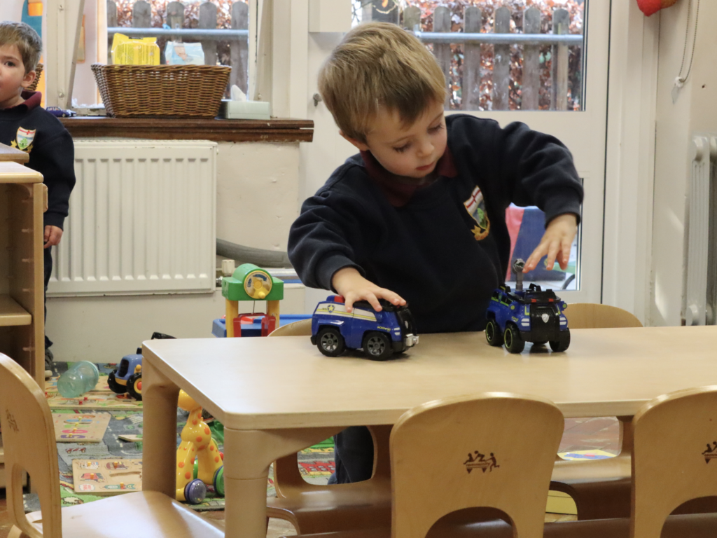 student playing with trains