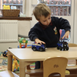 student playing with trains