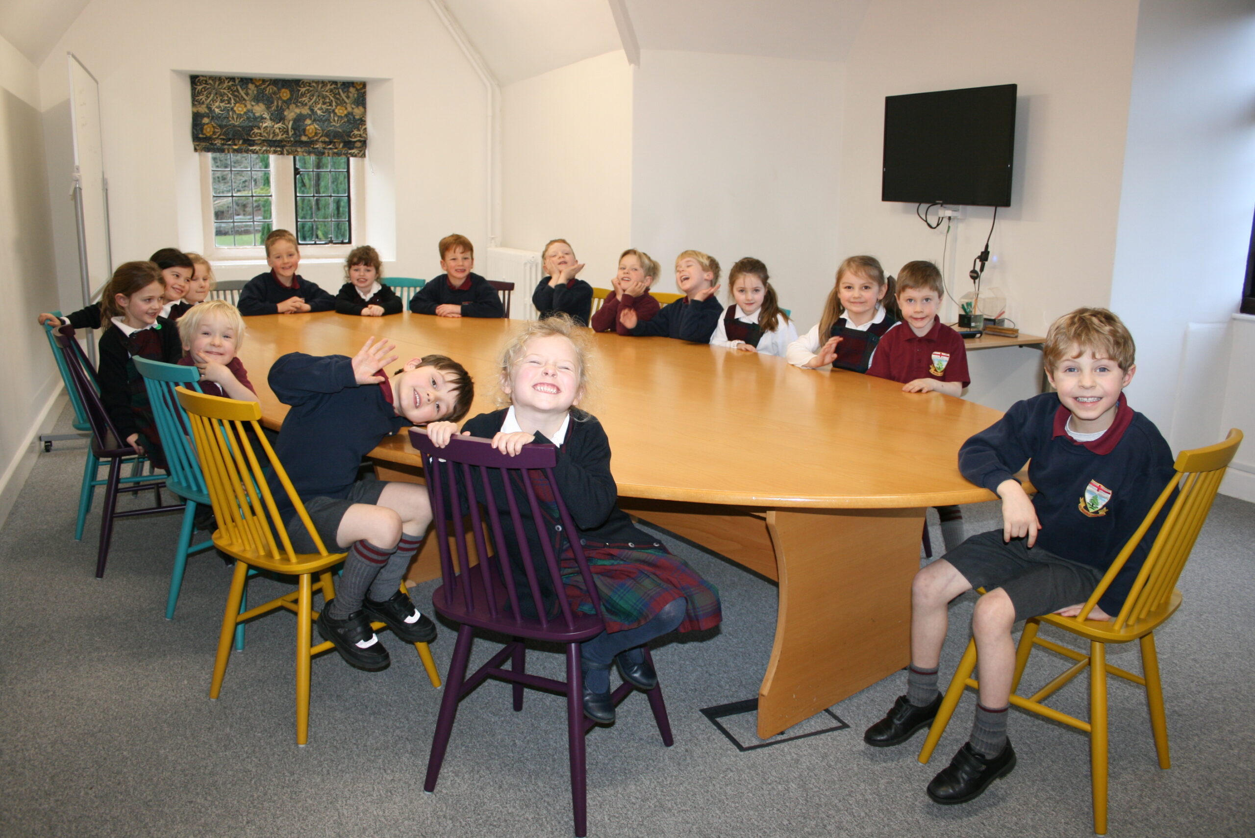 School children sat around the table ready for their studies