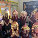 students wearing Egyptian masks